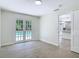 Living space features French doors to the pool and an open concept view to the kitchen at 34 Aaron Cir, Ormond Beach, FL 32174