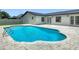 Inviting in-ground pool with brick trim surrounded by updated patio, perfect for relaxation and outdoor enjoyment at 34 Aaron Cir, Ormond Beach, FL 32174