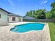 Backyard view of a private pool, patio, and well-manicured lawn at 34 Aaron Cir, Ormond Beach, FL 32174