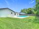 A well-maintained pool surrounded by a green lawn, offering a refreshing escape in the privacy of your backyard at 34 Aaron Cir, Ormond Beach, FL 32174