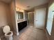 Bright bathroom featuring double vanity, tile floor and glass enclosed shower at 1509 Venice Ln, Davenport, FL 33896