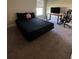 Simple bedroom design with black bedding, desk, black gaming chair and neutral walls at 1509 Venice Ln, Davenport, FL 33896