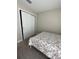 A bedroom featuring a closet with white doors, carpeted floors, and light gray walls at 1509 Venice Ln, Davenport, FL 33896