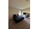 Simple bedroom design with black bedding, desk, black gaming chair and neutral walls at 1509 Venice Ln, Davenport, FL 33896