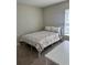 Cozy bedroom features a white metal bed frame, floral bedding and a table to the side, complemented by neutral walls at 1509 Venice Ln, Davenport, FL 33896