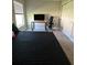 Functional bedroom design with black bedding, desk, black gaming chair, closet and neutral walls at 1509 Venice Ln, Davenport, FL 33896