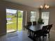Bright dining area with large sliding glass door and pond view at 1509 Venice Ln, Davenport, FL 33896
