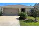 Inviting single story home featuring an attached garage and manicured lawn at 1509 Venice Ln, Davenport, FL 33896