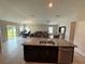 Open layout showcases kitchen with central island and barstool seating at 1509 Venice Ln, Davenport, FL 33896