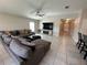 Open concept living room with ceiling fan, tile flooring and natural light at 1509 Venice Ln, Davenport, FL 33896