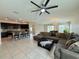 Open-concept living room boasts tile floors and lots of natural light at 1509 Venice Ln, Davenport, FL 33896