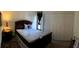 Bedroom with a full size bed, white closet doors, and natural light at 5310 Pebble Beach Dr # F, Orlando, FL 32811