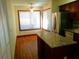Eat-in kitchen space includes stainless steel refrigerator, wood cabinets, and a granite-topped breakfast bar at 5310 Pebble Beach Dr # F, Orlando, FL 32811
