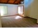 The sun-filled living room includes vaulted ceilings, carpet, and natural looking trim at 5310 Pebble Beach Dr # F, Orlando, FL 32811