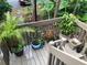 View of a porch of a home filled with lush plants and flowers in decorative pots at 5310 Pebble Beach Dr # F, Orlando, FL 32811