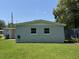 Rear home exterior with a tidy lawn, presenting a simple and clean aesthetic at 705 Grandview Ave, Altamonte Springs, FL 32701