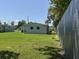 Large, well-maintained backyard with a dark grey concrete block fence on the right at 705 Grandview Ave, Altamonte Springs, FL 32701