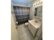 Compact bathroom featuring a vanity with a sink, toilet, and shower with a patterned curtain at 705 Grandview Ave, Altamonte Springs, FL 32701