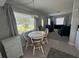 Cozy dining area showcasing a round table and four chairs, bathed in natural light from the window at 705 Grandview Ave, Altamonte Springs, FL 32701