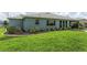 Green backyard featuring healthy lawn, tasteful landscaping and covered lanai at 10298 Sw 96Th Loop, Ocala, FL 34481