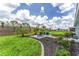 Grassy, landscaped backyard with a stone patio and space for entertaining at 10298 Sw 96Th Loop, Ocala, FL 34481