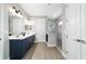Bright bathroom featuring double vanity sinks, glass shower, and modern fixtures at 10298 Sw 96Th Loop, Ocala, FL 34481