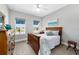 Cozy bedroom features a wooden bed frame and views to the outside at 10298 Sw 96Th Loop, Ocala, FL 34481