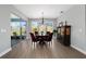 Dining room with wood floors, a chandelier, and views of the back yard at 10298 Sw 96Th Loop, Ocala, FL 34481