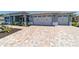 Attractive home boasting a double garage and patterned brick driveway at 10298 Sw 96Th Loop, Ocala, FL 34481