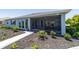 Exterior view of screened lanai with patio and sliding glass doors at 10298 Sw 96Th Loop, Ocala, FL 34481