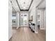 Bright foyer featuring wood floors and a decorative console table at 10298 Sw 96Th Loop, Ocala, FL 34481