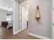 Hallway featuring an ornate mirror, with views to the bedroom and a separate room at 10298 Sw 96Th Loop, Ocala, FL 34481