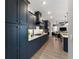 Modern kitchen featuring sleek, navy cabinetry and marble countertops at 10298 Sw 96Th Loop, Ocala, FL 34481