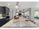 Spacious kitchen island with granite countertops, pendant lighting, and modern appliances perfect for entertaining at 10298 Sw 96Th Loop, Ocala, FL 34481