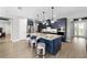 Spacious kitchen with modern appliances, navy cabinets, granite countertops, and a large center island at 10298 Sw 96Th Loop, Ocala, FL 34481