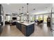 Open kitchen island with stainless steel appliances and seamless transition into dining and living area at 10298 Sw 96Th Loop, Ocala, FL 34481