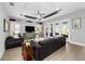 Cozy living room with stylish tray ceiling, French doors, and comfortable seating at 10298 Sw 96Th Loop, Ocala, FL 34481