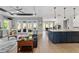 Open-concept living area with wood flooring and access to outdoor patio at 10298 Sw 96Th Loop, Ocala, FL 34481