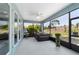 Relaxing screened patio featuring a hot tub, ceiling fan, and expansive views at 10298 Sw 96Th Loop, Ocala, FL 34481