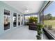 Enclosed patio with tiled floor, ceiling fan, hot tub, and views of the backyard at 10298 Sw 96Th Loop, Ocala, FL 34481