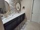 Beautiful bathroom features a double sink vanity, granite counters, stylish mirrors, and unique stone accent wall at 1521 Sourwood Dr, Ocoee, FL 34761