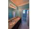 Bright bathroom featuring a dual granite vanity and tiled floors at 1521 Sourwood Dr, Ocoee, FL 34761