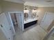 Bathroom boasts a double sink vanity, stone accent wall, and well-lit mirrors on a tile floor at 1521 Sourwood Dr, Ocoee, FL 34761
