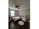 Cozy bedroom with ceiling fan, natural light, and hardwood flooring at 1521 Sourwood Dr, Ocoee, FL 34761