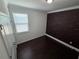 Small bedroom with hardwood flooring, and natural light at 1521 Sourwood Dr, Ocoee, FL 34761