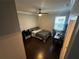 Bedroom with ceiling fan, hardwood floors, a window with blinds, and closet at 1521 Sourwood Dr, Ocoee, FL 34761