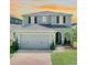 Charming two-story home with a well-maintained lawn, a two-car garage, and beautiful landscaping at 1521 Sourwood Dr, Ocoee, FL 34761