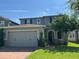 Charming two-story home with a well-maintained lawn, a two-car garage, and beautiful landscaping at 1521 Sourwood Dr, Ocoee, FL 34761
