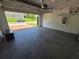View of a two car garage with epoxy flooring and plenty of storage space at 1521 Sourwood Dr, Ocoee, FL 34761
