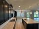 Modern kitchen features a large island, stainless steel appliances, quartz counters, and an open floorplan at 1521 Sourwood Dr, Ocoee, FL 34761